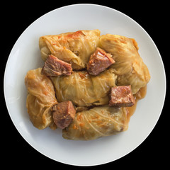 Plateful Of Cabbage Rolls Stuffed With Minced Meat Cooked In Tomato Sauce With Smoked Pork Ham Chunks