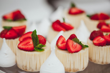 Dessert - sweet cake with strawberry on a plate white meringue