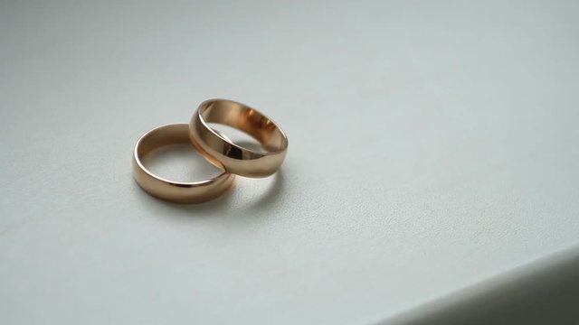 Wedding rings on the white table, background