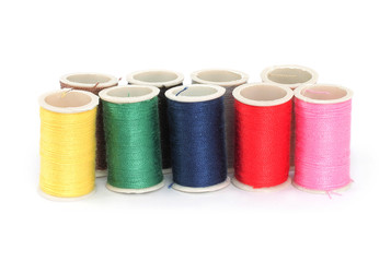 Color bobbins of thread on white background