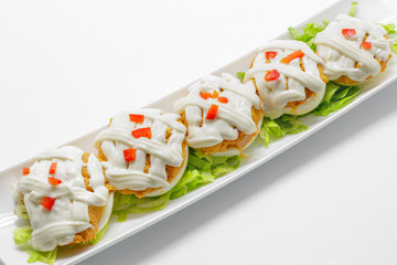 Stuffed eggs with tuna, tomato, mayonnaise and red pepper on whi