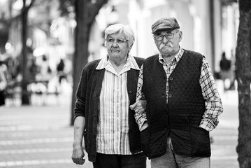 mature couple walking on street in autumn day