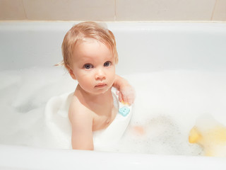 little 1,5 year-old baby boy playing in bath