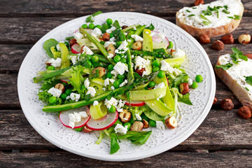 Fresh Green Asparagus salad witch Goat Cheese, peas, radishe, zucchini, lettuce and Hazelnuts.