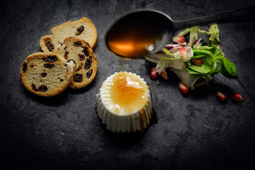 Fresh cheese and Honey with salad of fresh vegetables and pomegr