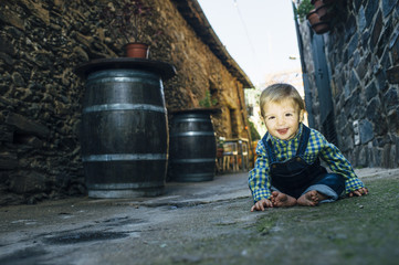 Happy baby barefoot in the street