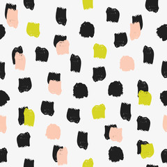Seamless pattern with brush strokes in black, peach and green on cream background.