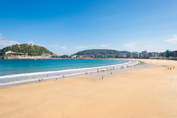 Obraz premium The Beach of La Concha Donostia, a sand beach with shallow waters and tide. It is one of the most famous urban beaches in Europe. Donostia San Sebastian is European Capital of Culture 2016