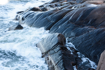 Rolling wave slamming on the rocks of the Finnish coastline