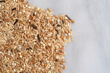 Blend of rice and grains on a marble cutting board top view.