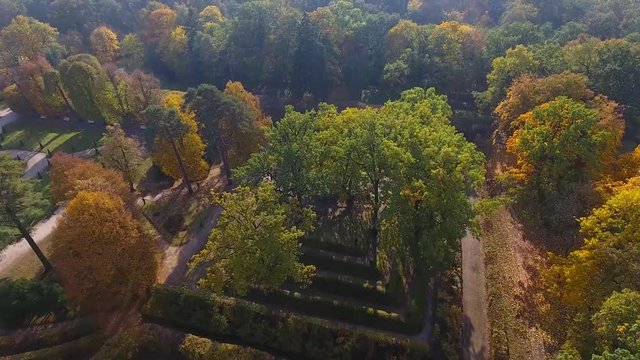 Amazing Autumn scenery, Park with Fall colors and Palace in Rogalin, Poland Aerial view.