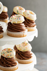 Cupcakes with chocolate frosting and little donuts