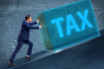 Businessman in high taxes concept
