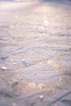 Winter background with shining snow and snowflakes on ice as Christmas background