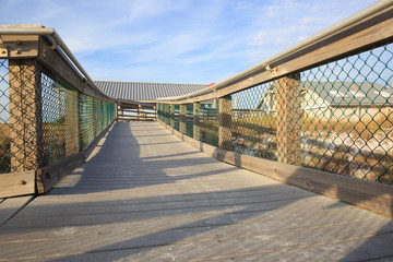 Fototapeta premium Stairs To The Beach. Wooden stairway leads to the wide sandy bea