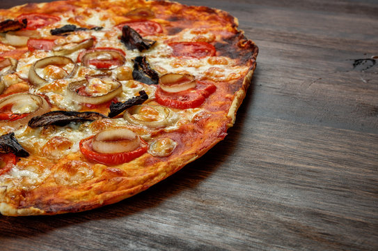 Pizza with tomatoes, mushrooms an cheese on dark background