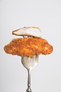 breaded cutlet on fork