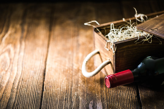 Red Wine Bottle And Wooden Crate