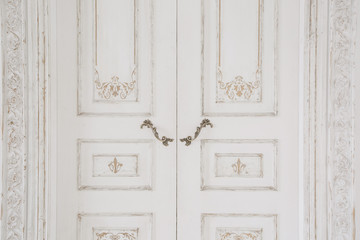 Old-style door, white - handle closeup. antiques interior