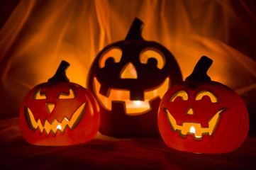 Spooky Halloween scene with Jack-o-Lanterns and candles glowing on a mysterious background