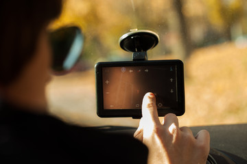 man  adjusting  gps in car