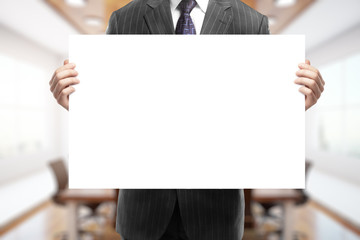 Businessman holding blank poster