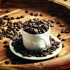 Coffee beans in a cup on a tray, selective focus