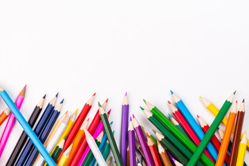 Fototapeta premium Color pencils topsy-turvy pile with white space
