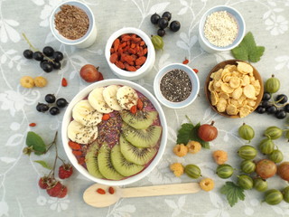fruit yogurt smoothie, berries and seeds for decorating bowls