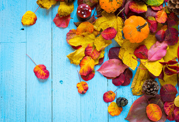 Colorful autumn leaves, over a wooden background