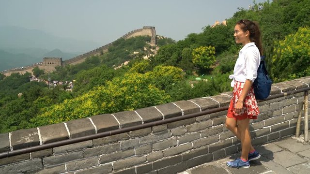 China travel at Great Wall. Tourist in Asia walking on famous Chinese tourist destination and attraction in Badaling north of Beijing. Woman traveler hiking great wall enjoying her summer vacation.