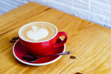 late art in red cup on wood table look delicious