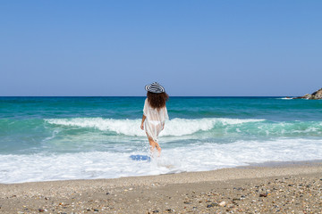 Fototapeta na wymiar Carefree sensual emotional bikini woman walking barefoot on the beach