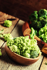 Green cauliflower, old wooden background, selective focus
