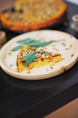 Classic American dessert for thanksgiving - pumpkin pie with a thin layer of dough, blurred focus, close-up.