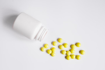 tablets in plastic container top view