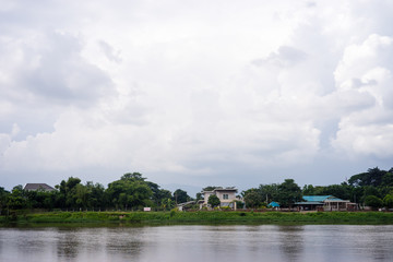 landscape house near river in cloudy day