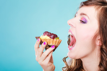 woman face profile open mouth eating cake