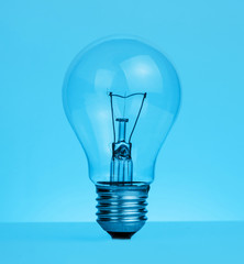 retro vintage light bulb with on blue tint background