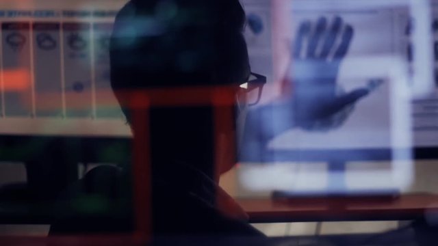 double exposure shot of man hacker working at a computer using touchscreen