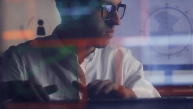 double exposure shot of man with glasses working at computer