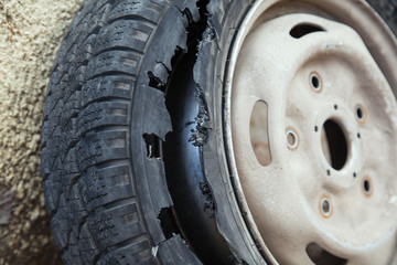 damaged wheel with the destroyed dilapidated tire