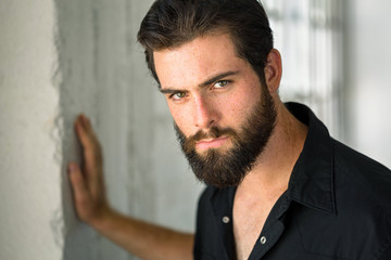 Handsome intense eyes headshot from man with passionate glare expression manly beard