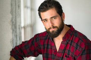 Head shot portrait of an easy going casual man with beard flannel mellow lovable gentle