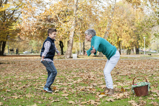 Boy running to grandmother in the park
