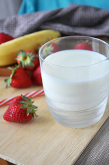 Glass of Milk on Wooden Background