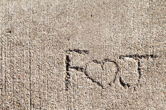 F heart J written in concrete