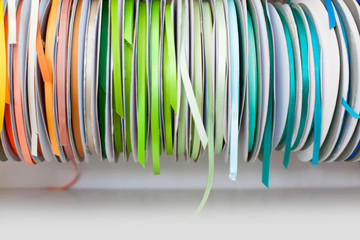 Rep and satin ribbons hanging in large reels. 