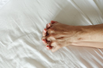 hand of women pulling white sheets in ecstasy, orgasm.