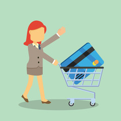 businesswoman with credit card and trolley